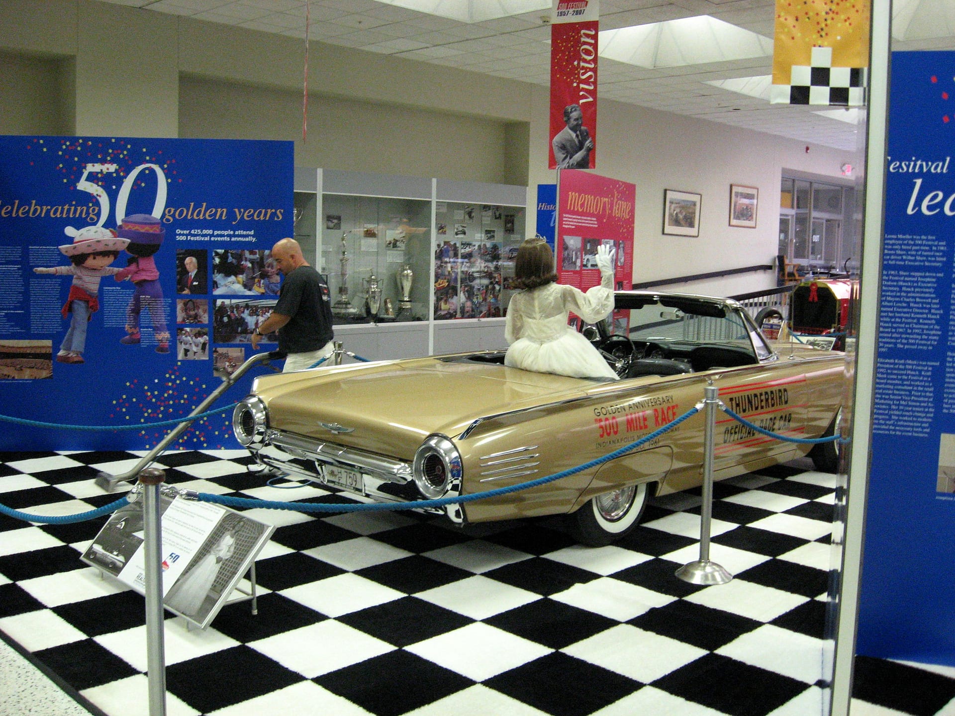 Cleaning the floor of a car museum display